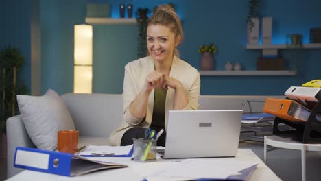 Home-office-worker-woman-making-cute-gesture-at-camera.